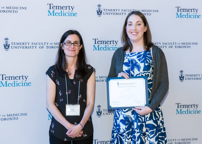 Patricia Lindsay, Director of the Physics Residency Program, presents the graduation certificate to Heather Young.