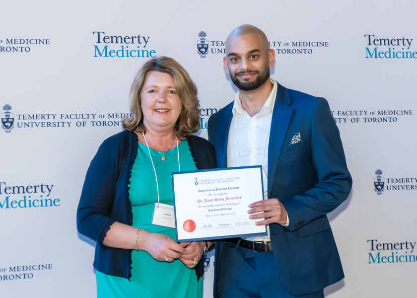 Andrea Bezjak, Director of the Radiation Oncology Residency Program, presents the graduation certificate to Jason Fernandes.
