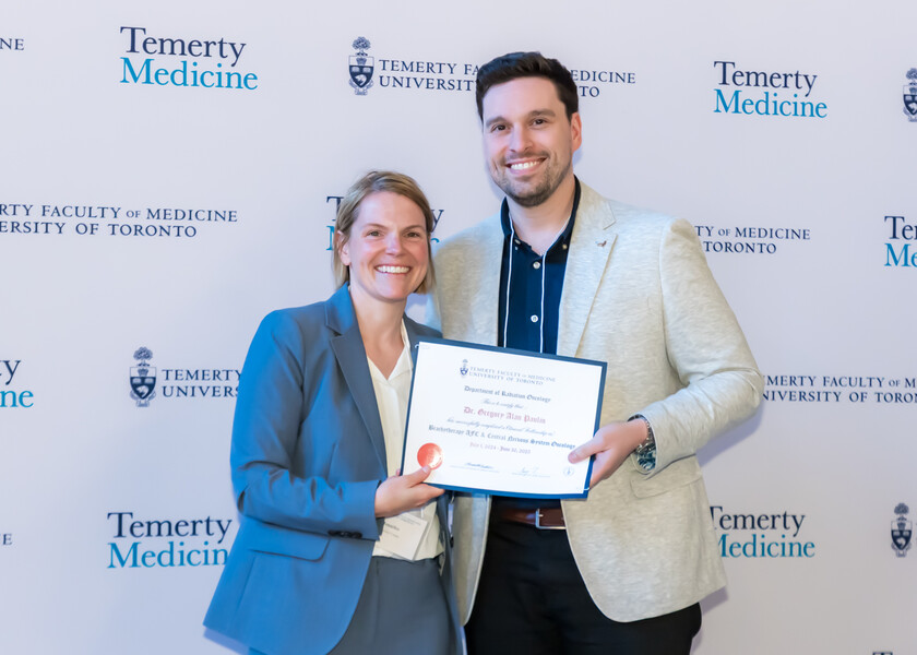 Jennifer Croke, Director of the Radiation Oncology Fellowship Program, presents the graduation certificate to Gregory Paulin.