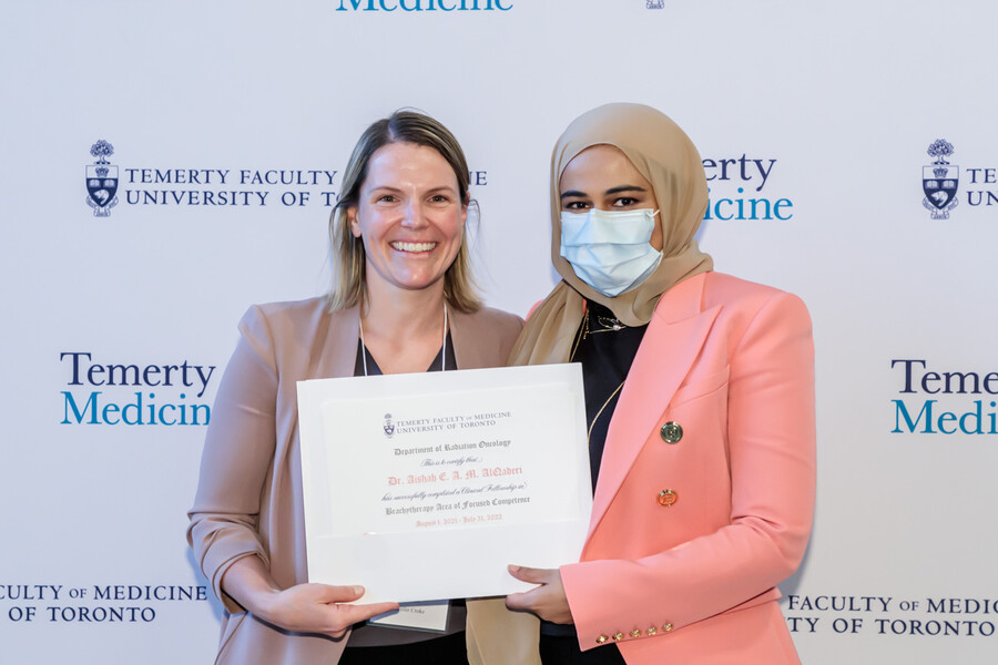 Dr. Jennifer Croke presents certificate to Dr. Aishah AlQaderi at the UTDRO Post-Grad 2022 Graduation Ceremony
